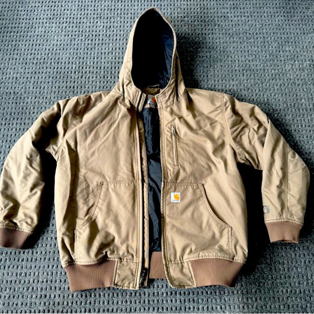 Large Carhartt jacket. New condition/never worn but was stored in smoking house